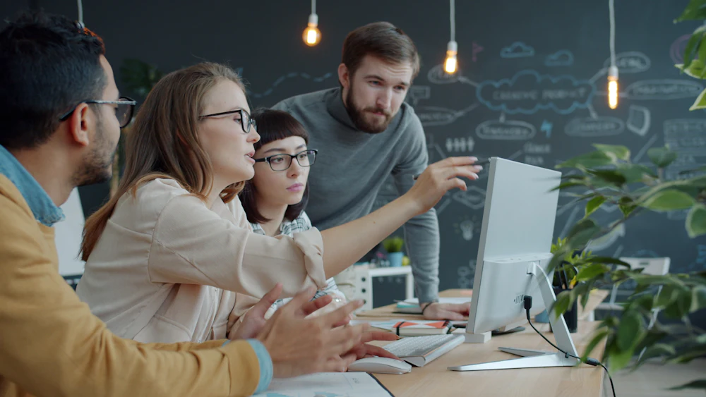 IT team collaborating around a computer
